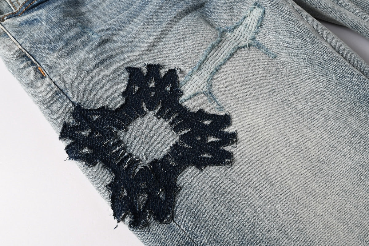 Amiri jeans light blue with black distressed patches