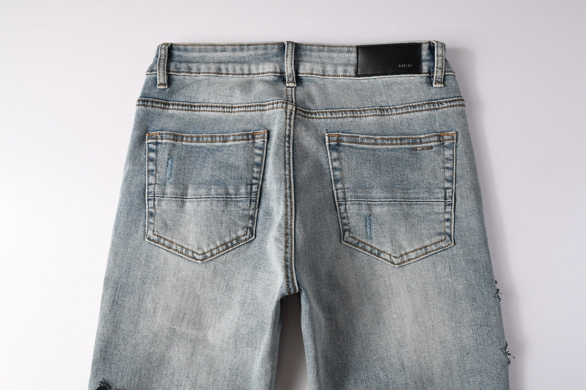 Amiri jeans light blue with black distressed patches