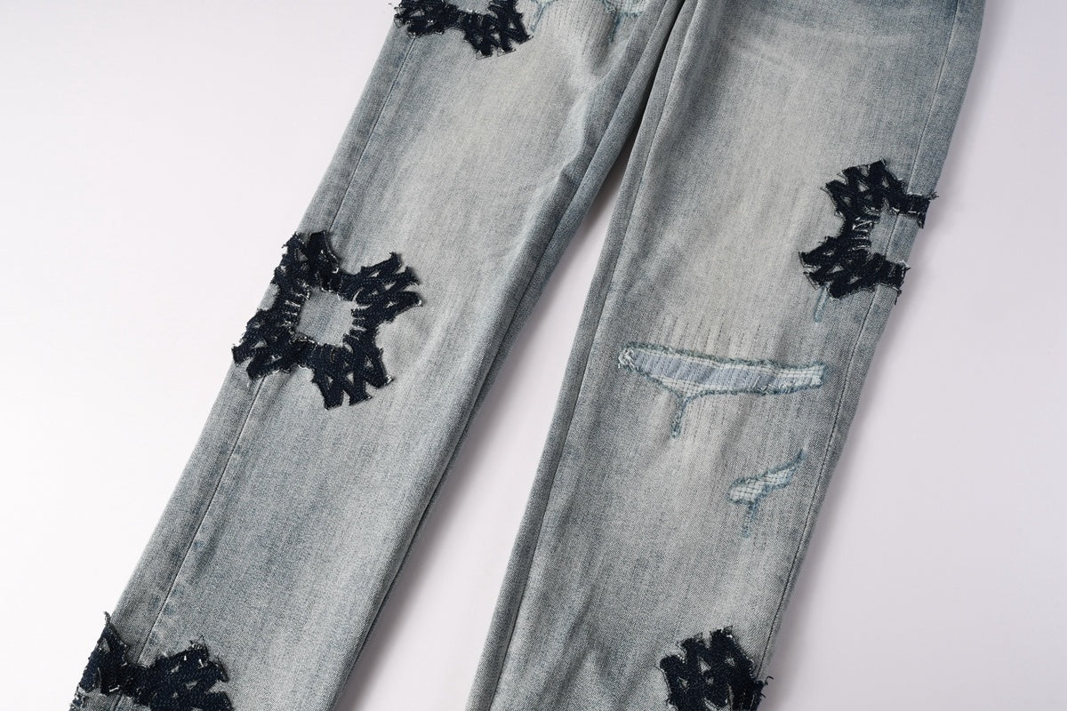 Amiri jeans light blue with black distressed patches