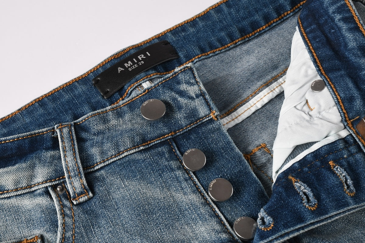 Amiri jeans light blue with black distressed patches