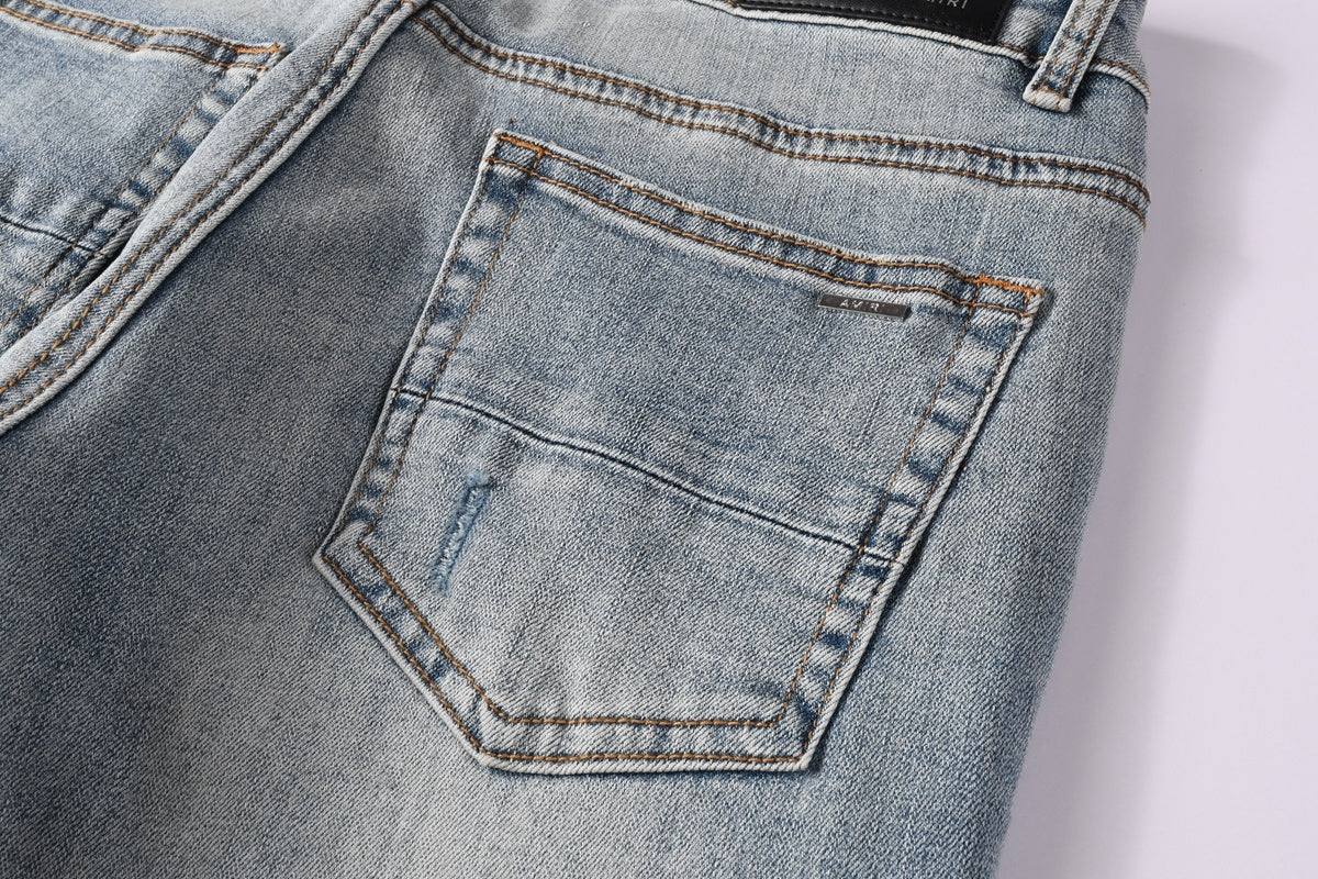Amiri jeans light blue with black distressed patches
