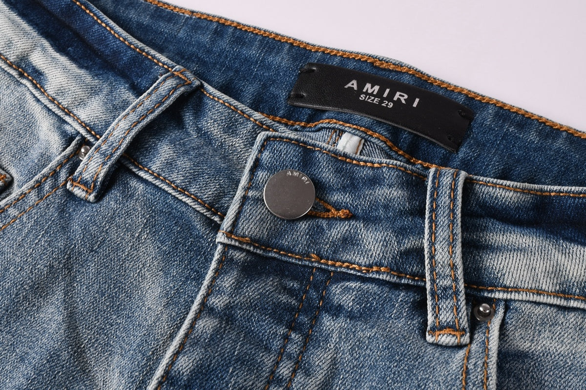 Amiri jeans light blue with black distressed patches