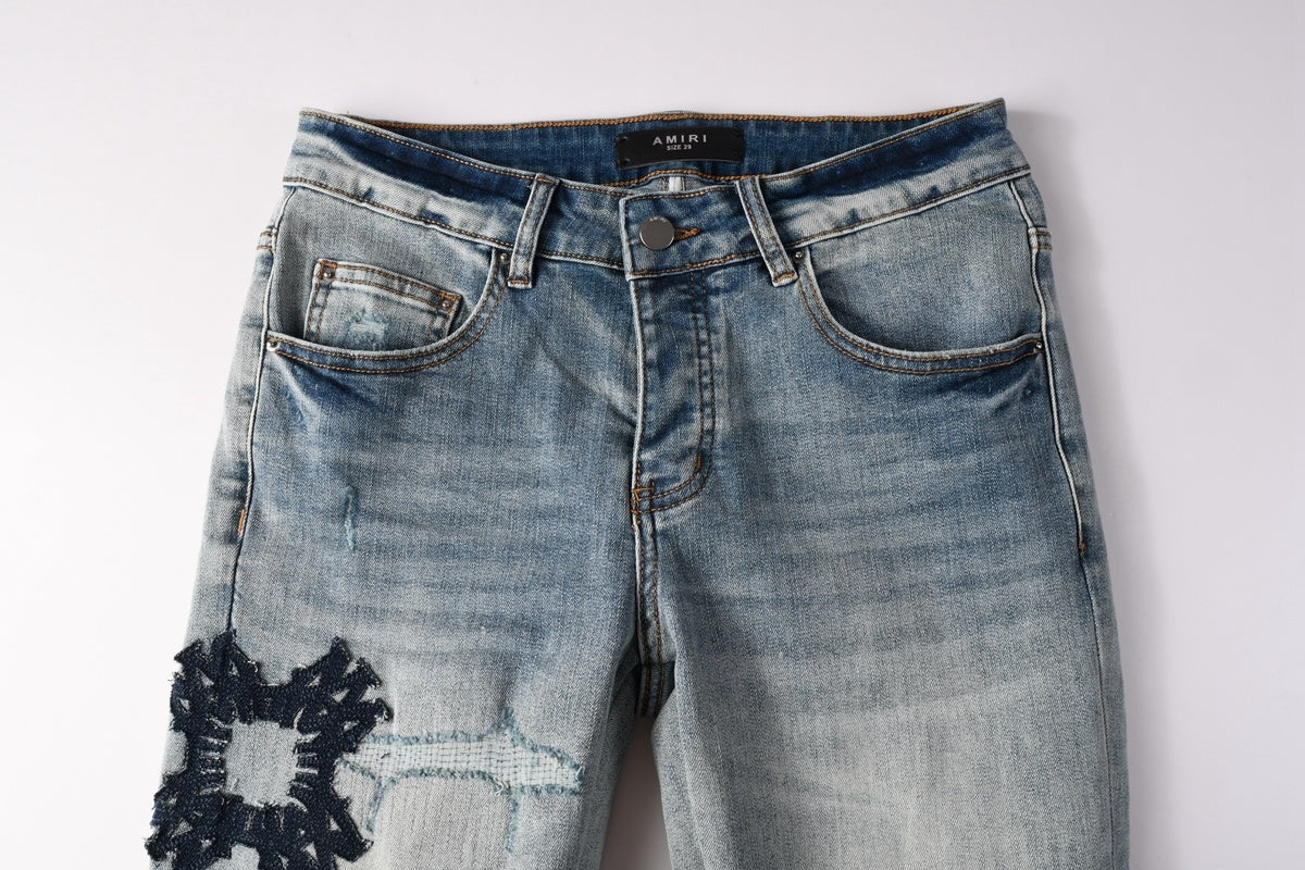 Amiri jeans light blue with black distressed patches
