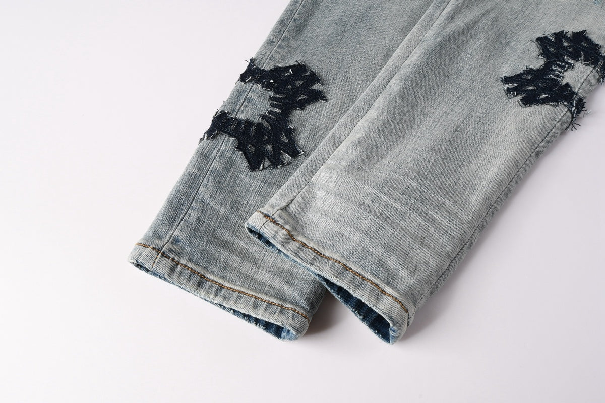 Amiri jeans light blue with black distressed patches